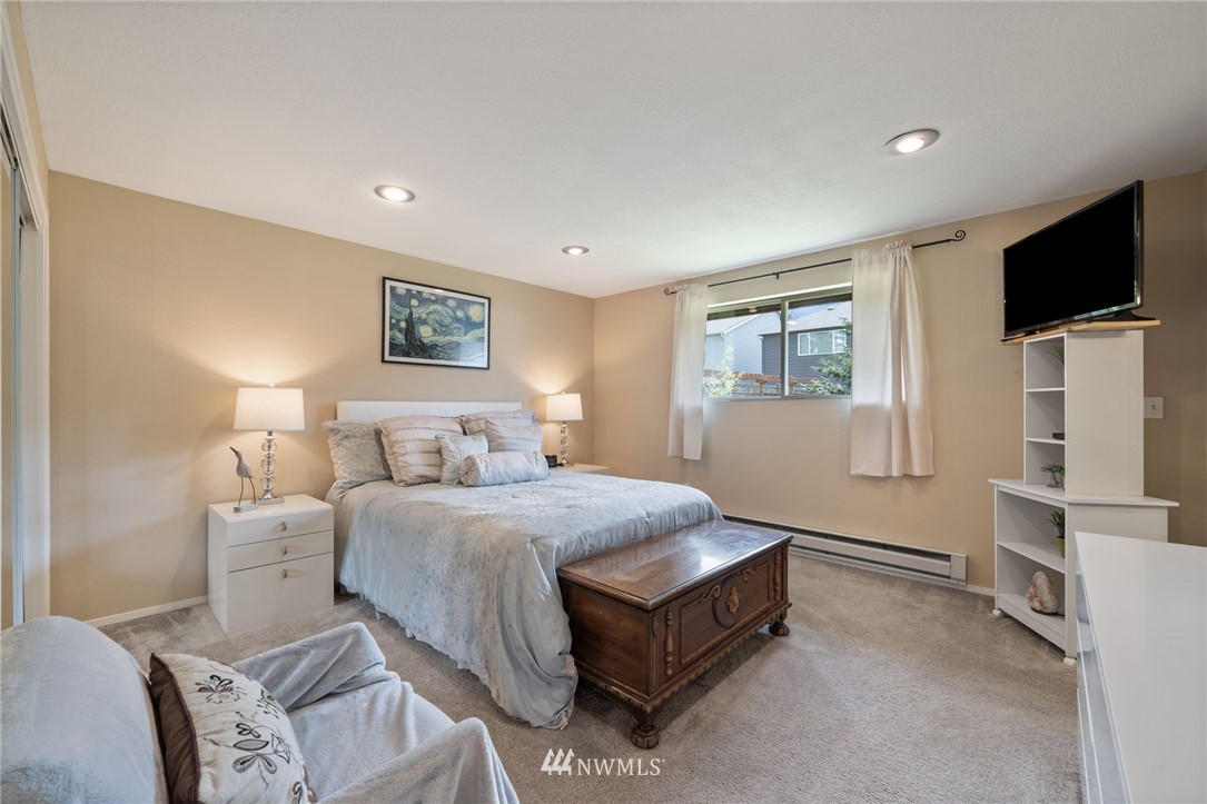 128 183rd Street Southwest Bothell, WA 98012 - Photo 15 of 33 a bedroom with a bed and a flat screen tv