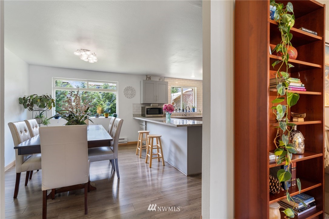 128 183rd Street Southwest Bothell, WA 98012 - Photo 7 of 33 a dining room with furniture floor to ceiling window and potted plants