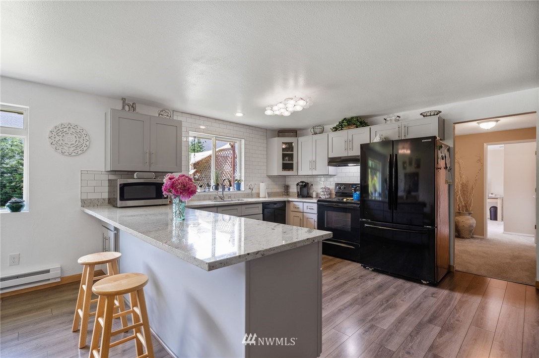128 183rd Street Southwest Bothell, WA 98012 - Photo 8 of 33 a large kitchen with lots of counter space and stainless steel appliances
