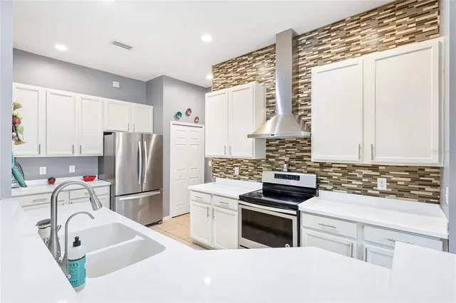 a kitchen with refrigerator and stove