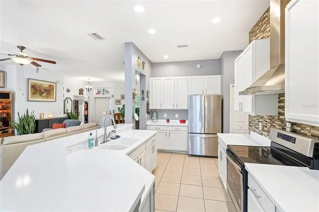 a kitchen with refrigerator and cabinets