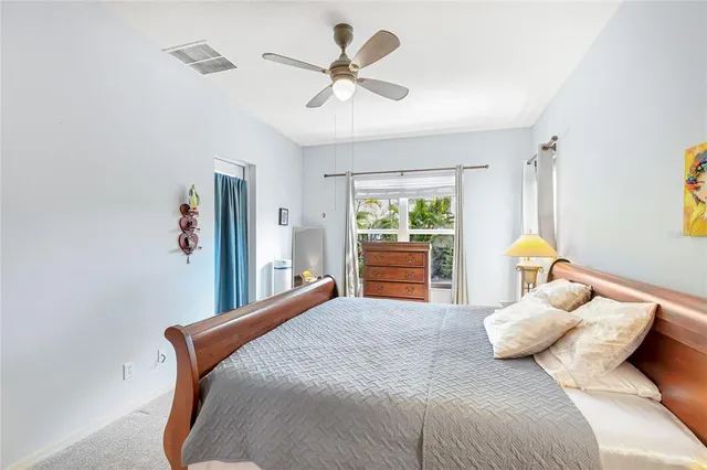 a bedroom with a bed and ceiling fan