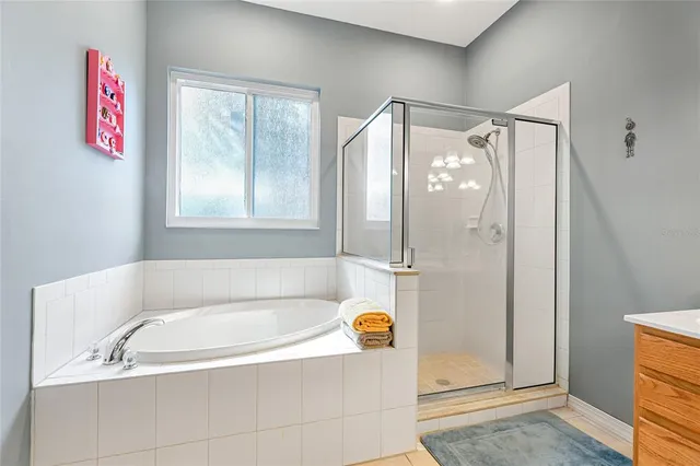 a white bath tub sitting next to a shower