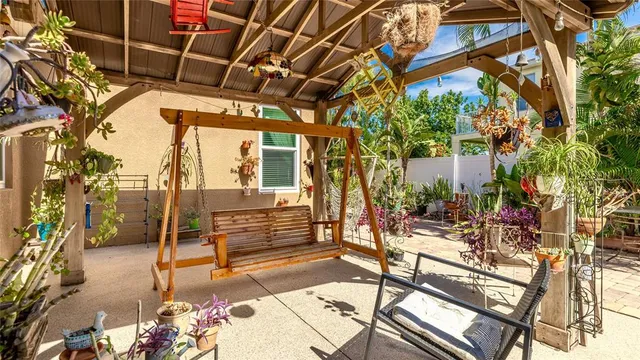 a view of a patio with a table and chairs and potted plants