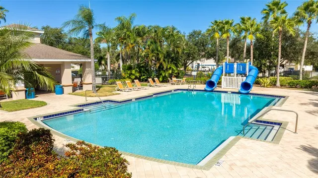 a view of a house with swimming pool and sitting area