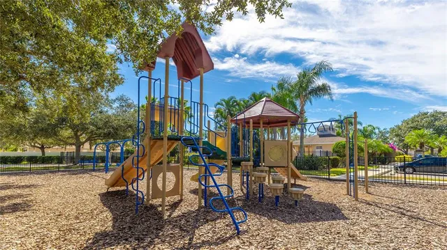 a view of tall trees with sign board