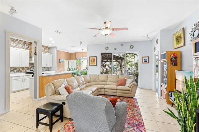 a living room with furniture ceiling fan and a rug
