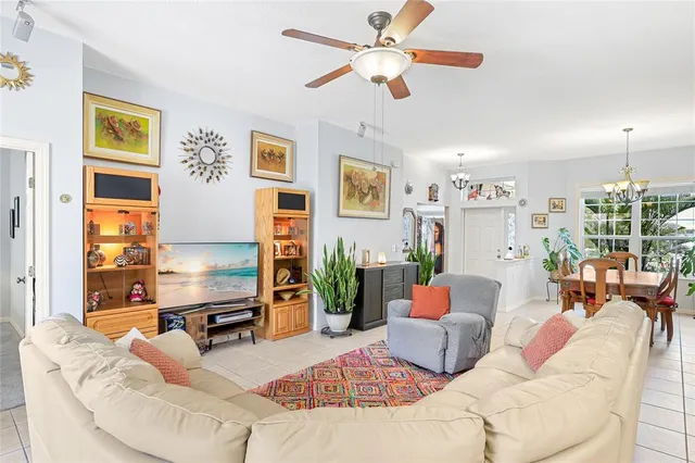 a living room with furniture kitchen view and a large window