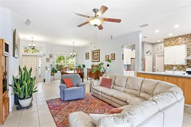 a living room with furniture or chandelier and a dining table