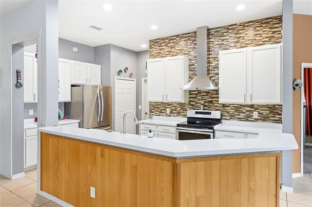 a kitchen with stainless steel appliances a sink and a refrigerator
