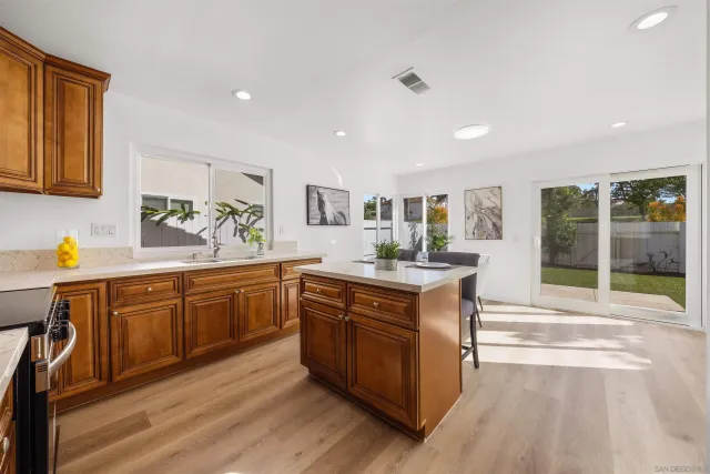 a kitchen with stainless steel appliances granite countertop a sink stove and cabinets