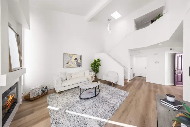 a living room with furniture a chandelier and a fireplace