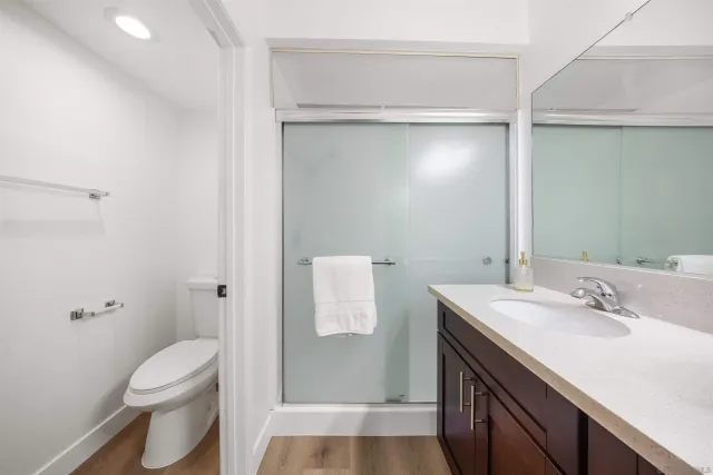 a bedroom with a bed and a wall painting