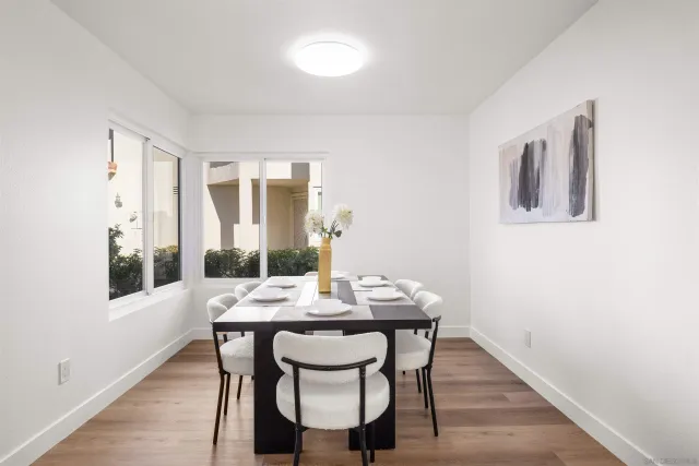 a view of a dining room with furniture and wooden floor