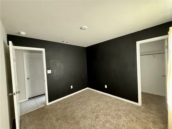 a view of a backyard with a barbeque and wooden fence