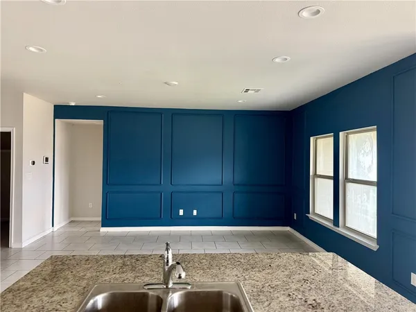 a kitchen with stainless steel appliances granite countertop a stove a refrigerator and a sink