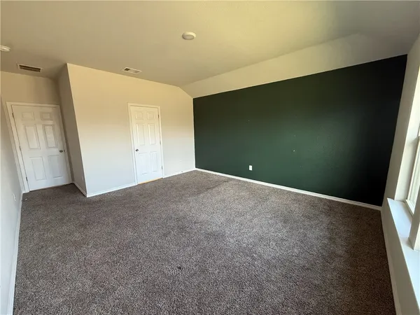 a view of a hallway to rooms