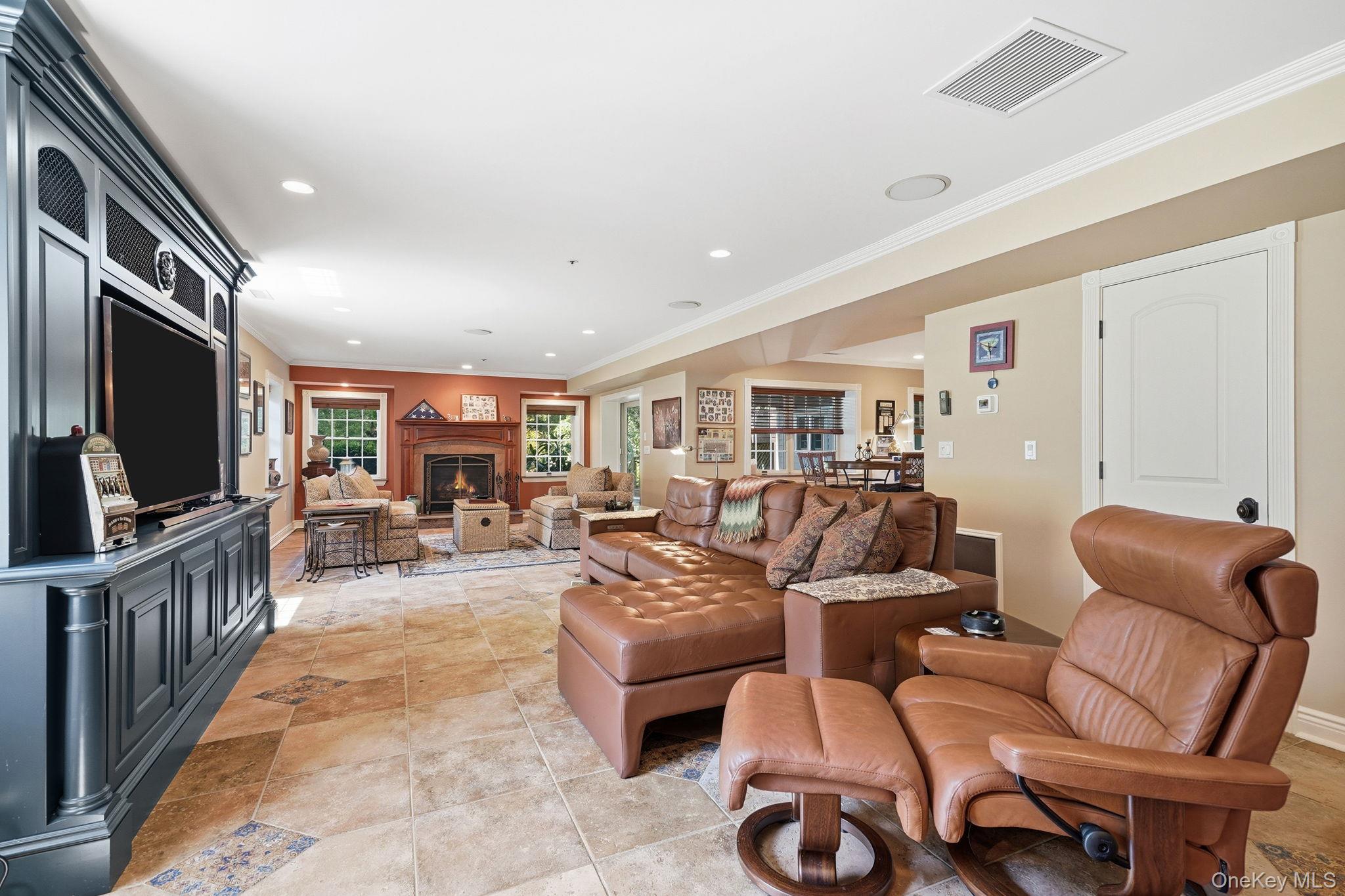 33 Hevelyne Road Elmsford, NY 10523 - Photo 30 of 43 Family room with gas fireplace in terrace level with Bar and walk-out access to patio.