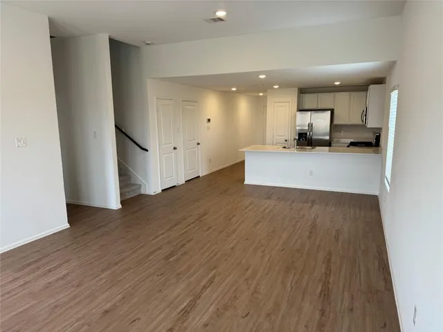 a view of a kitchen with a sink and a refrigerator