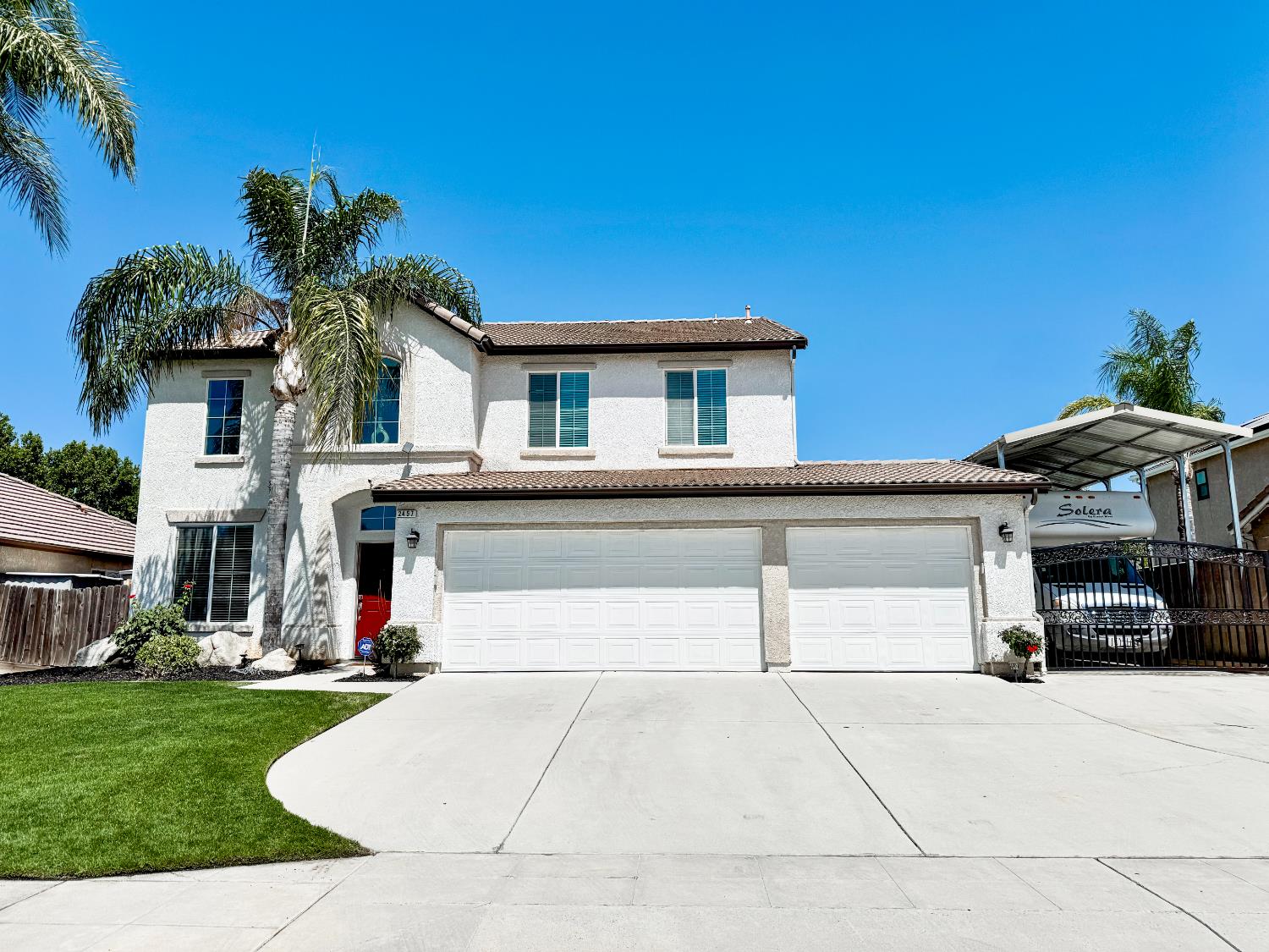 a front view of a house with a yard and a garage