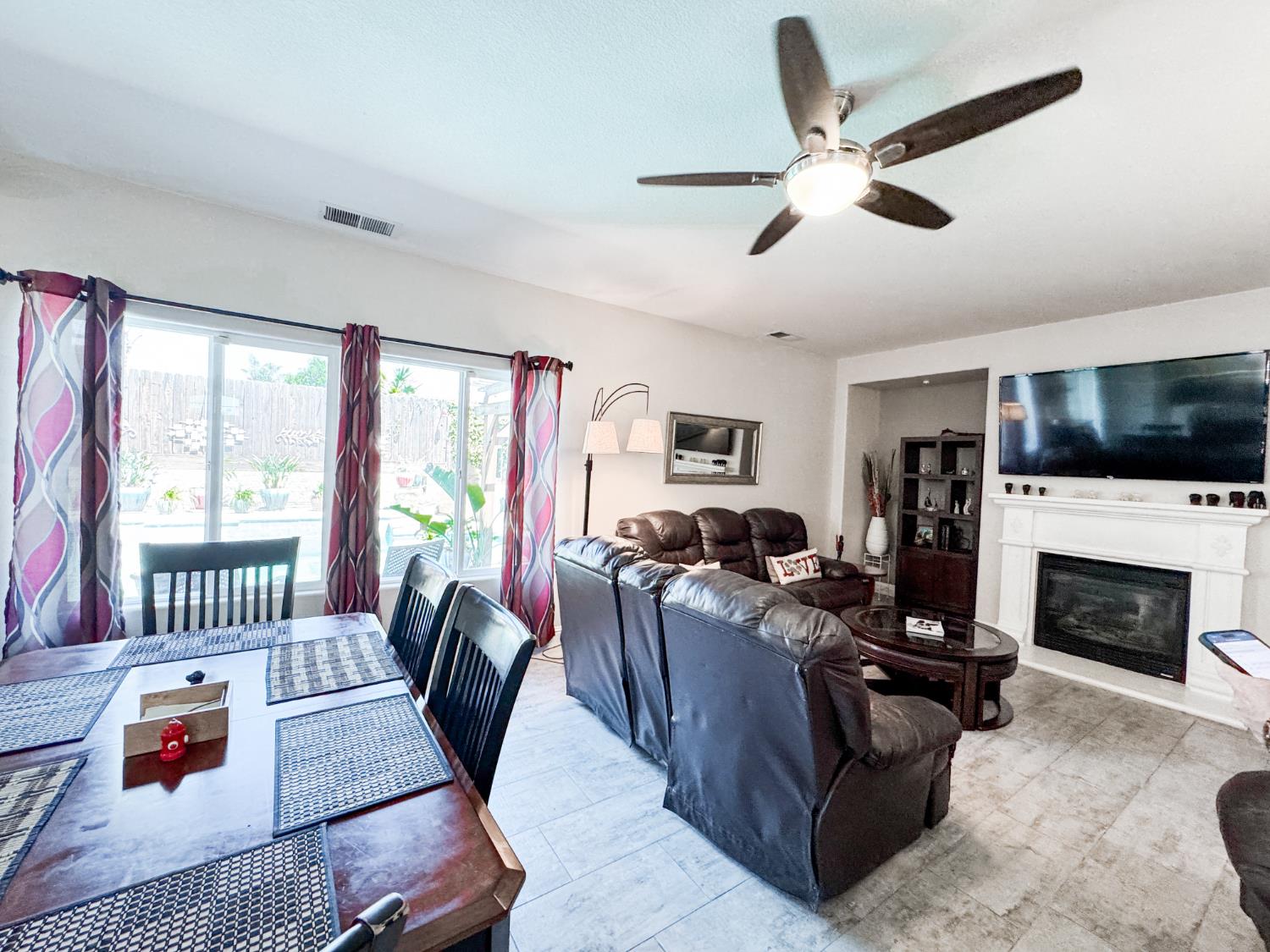 2457 Carson Avenue Clovis, CA 93611 - Photo 11 of 33 a living room with furniture fireplace and flat screen tv