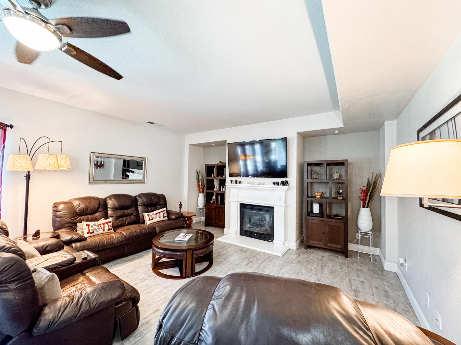 2457 Carson Avenue Clovis, CA 93611 - Photo 13 of 33 a living room with furniture a flat screen tv and a fireplace