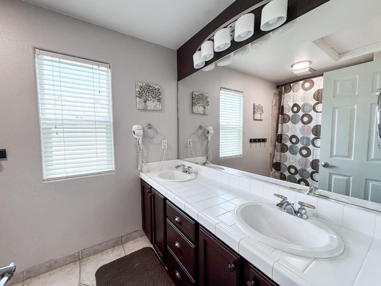 2457 Carson Avenue Clovis, CA 93611 - Photo 19 of 33 a bathroom with double vanity and a mirror