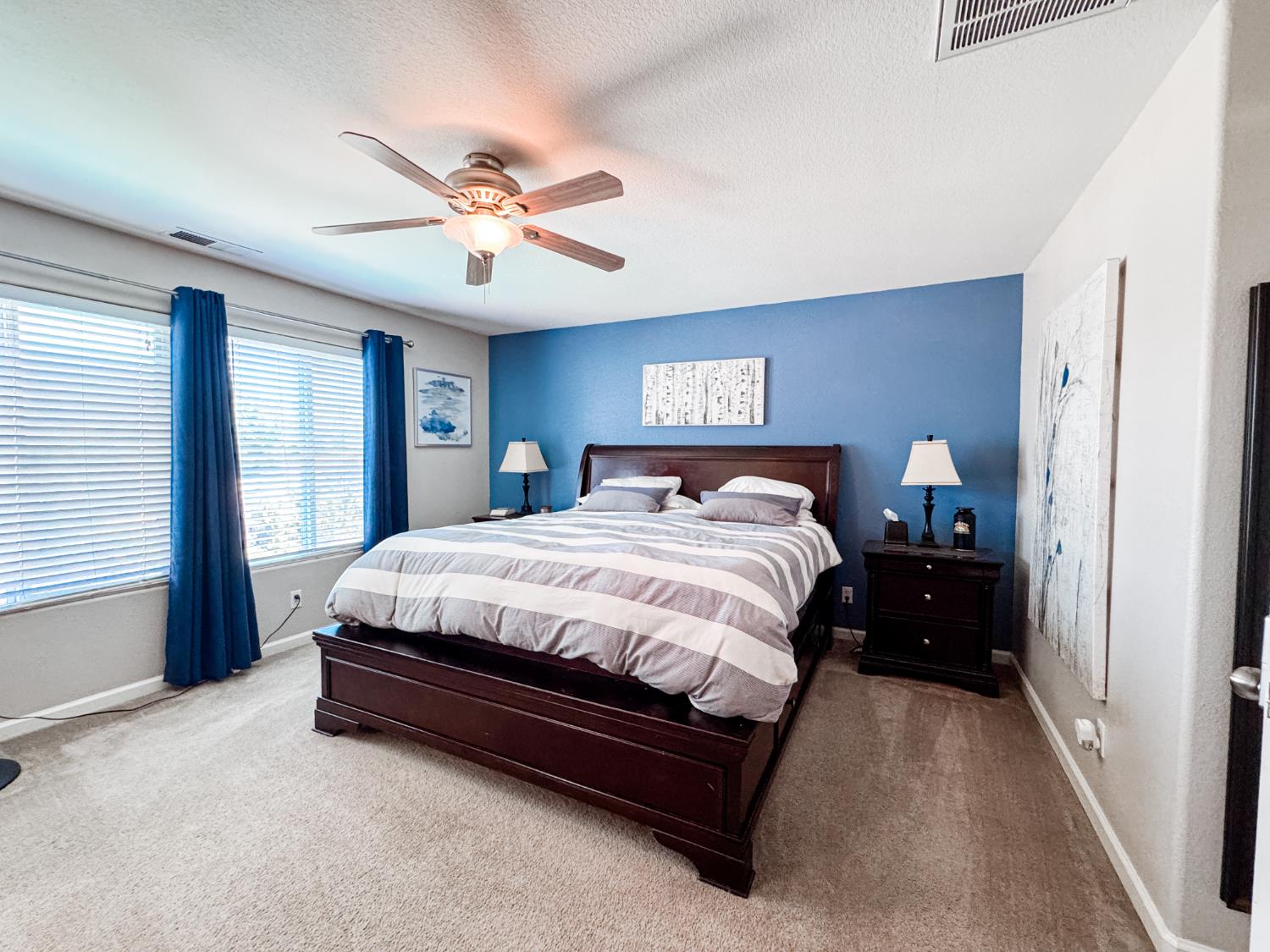2457 Carson Avenue Clovis, CA 93611 - Photo 23 of 33 a spacious bedroom with a bed and a chandelier