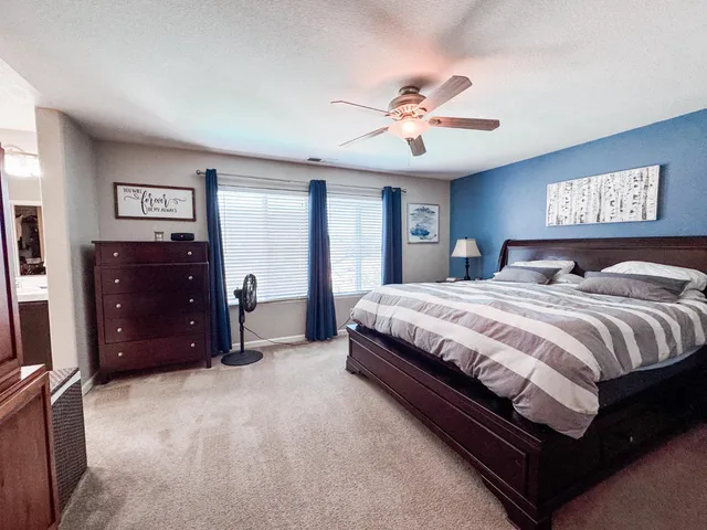 a bedroom with a large bed and a dresser