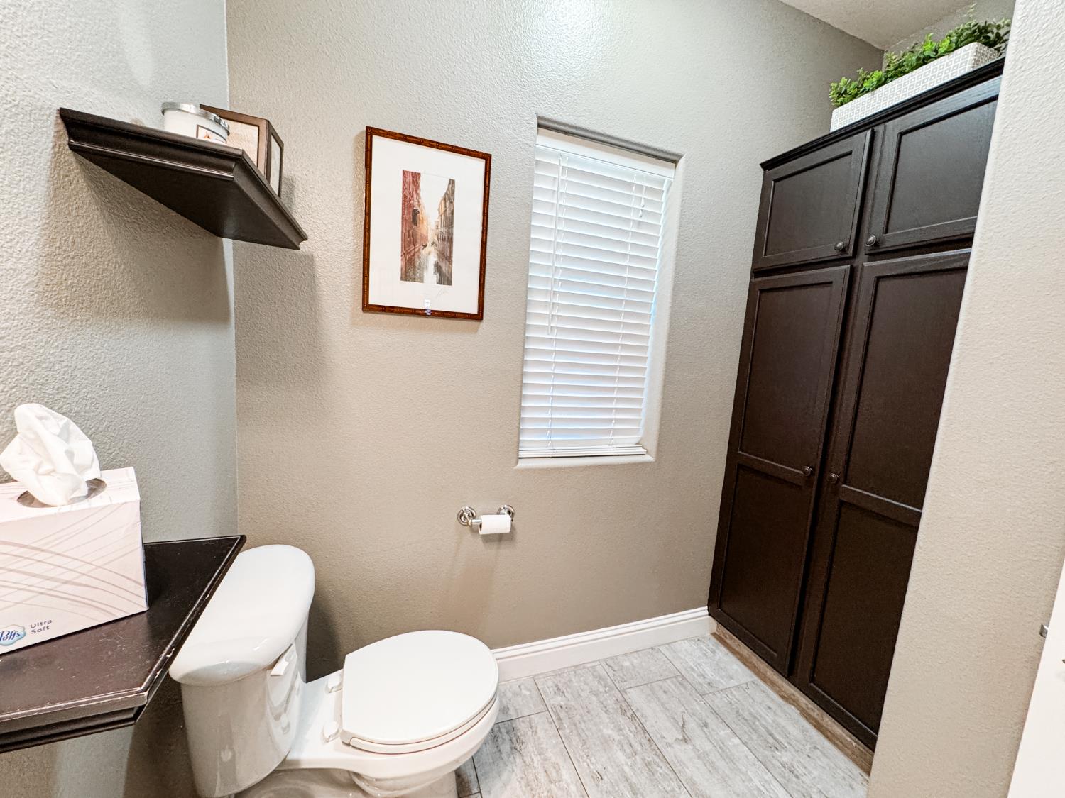 2457 Carson Avenue Clovis, CA 93611 - Photo 7 of 33 a white toilet sitting next to a window