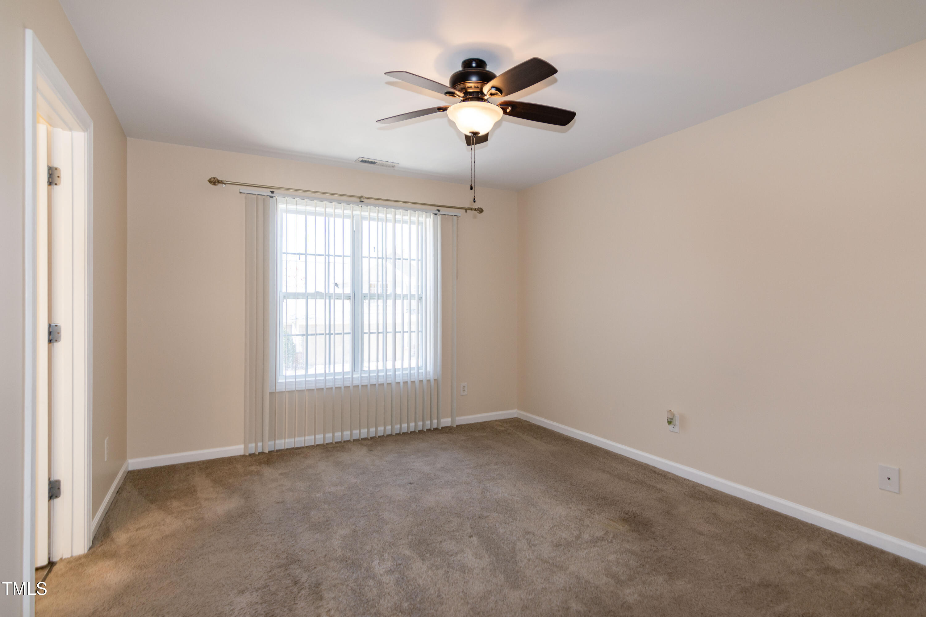 2638 Andover Glen Road Raleigh, NC 27604 - Photo 25 of 49 an empty room with a ceiling fan and window