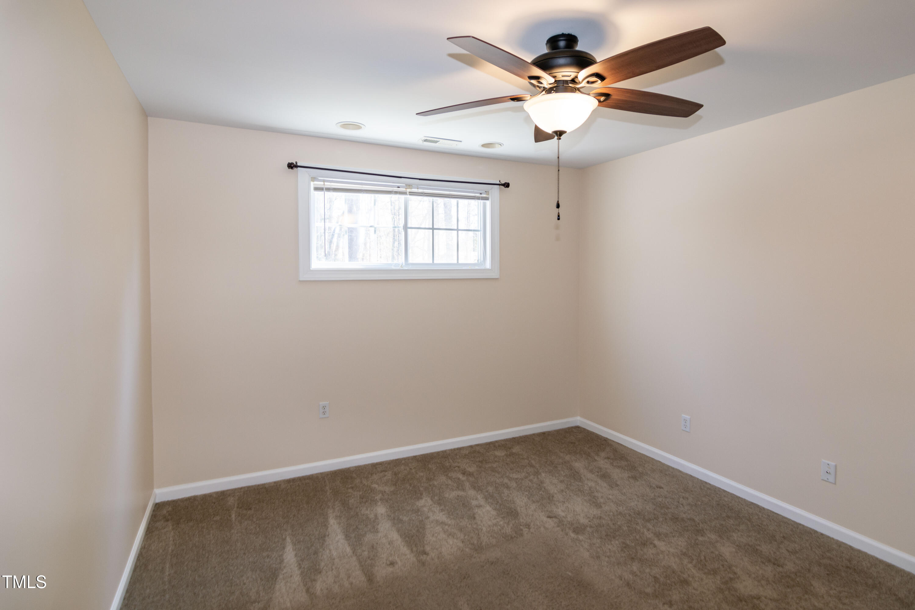 2638 Andover Glen Road Raleigh, NC 27604 - Photo 43 of 49 an empty room with a window and a fan