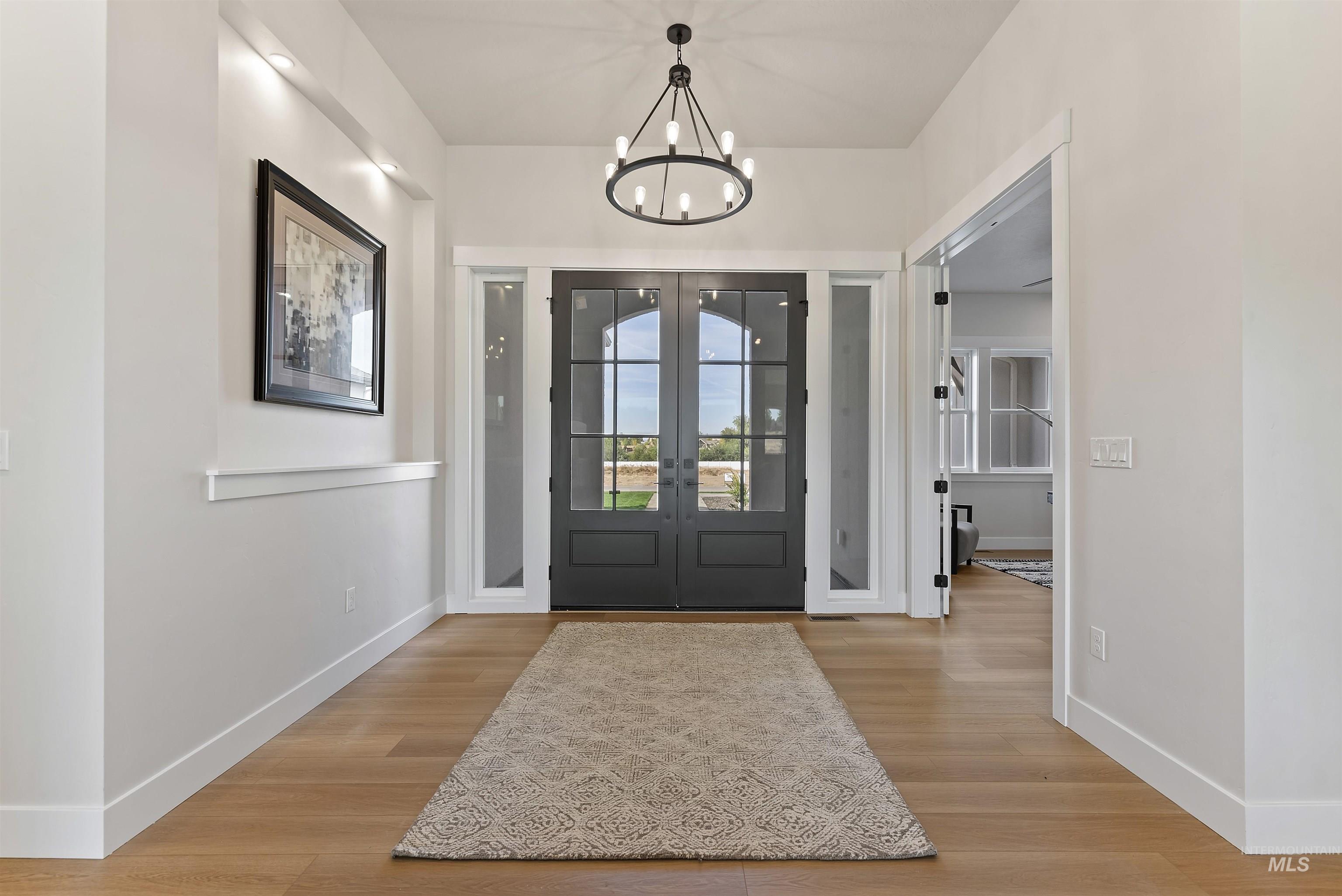 24864 Ardmore Court Caldwell, ID 83607 - Photo 11 of 48 Foyer entrance featuring light wood-type flooring and a chandelier