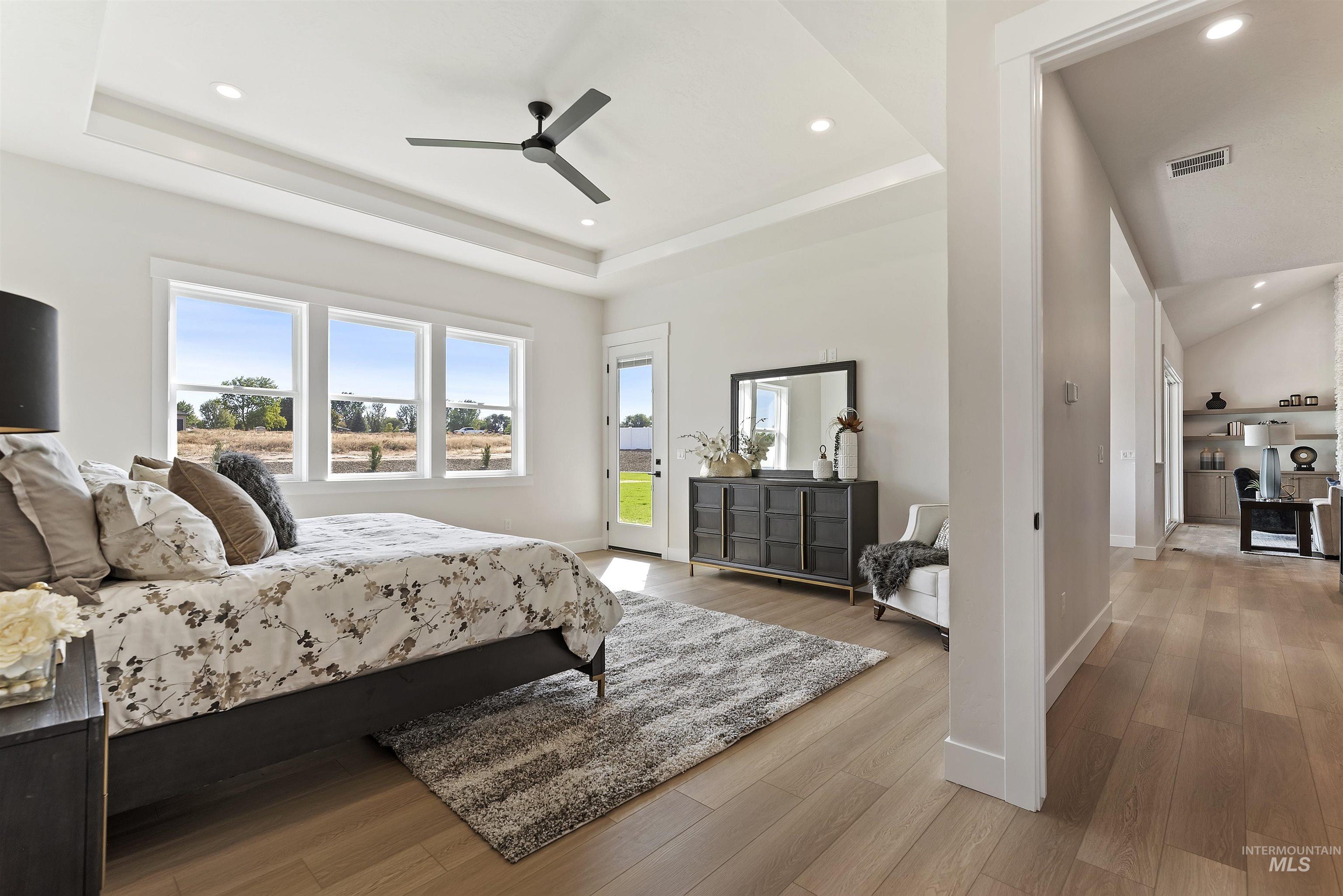 24864 Ardmore Court Caldwell, ID 83607 - Photo 21 of 48 Bedroom with access to outside, light wood-type flooring, ceiling fan, recessed lighting, and a raised ceiling