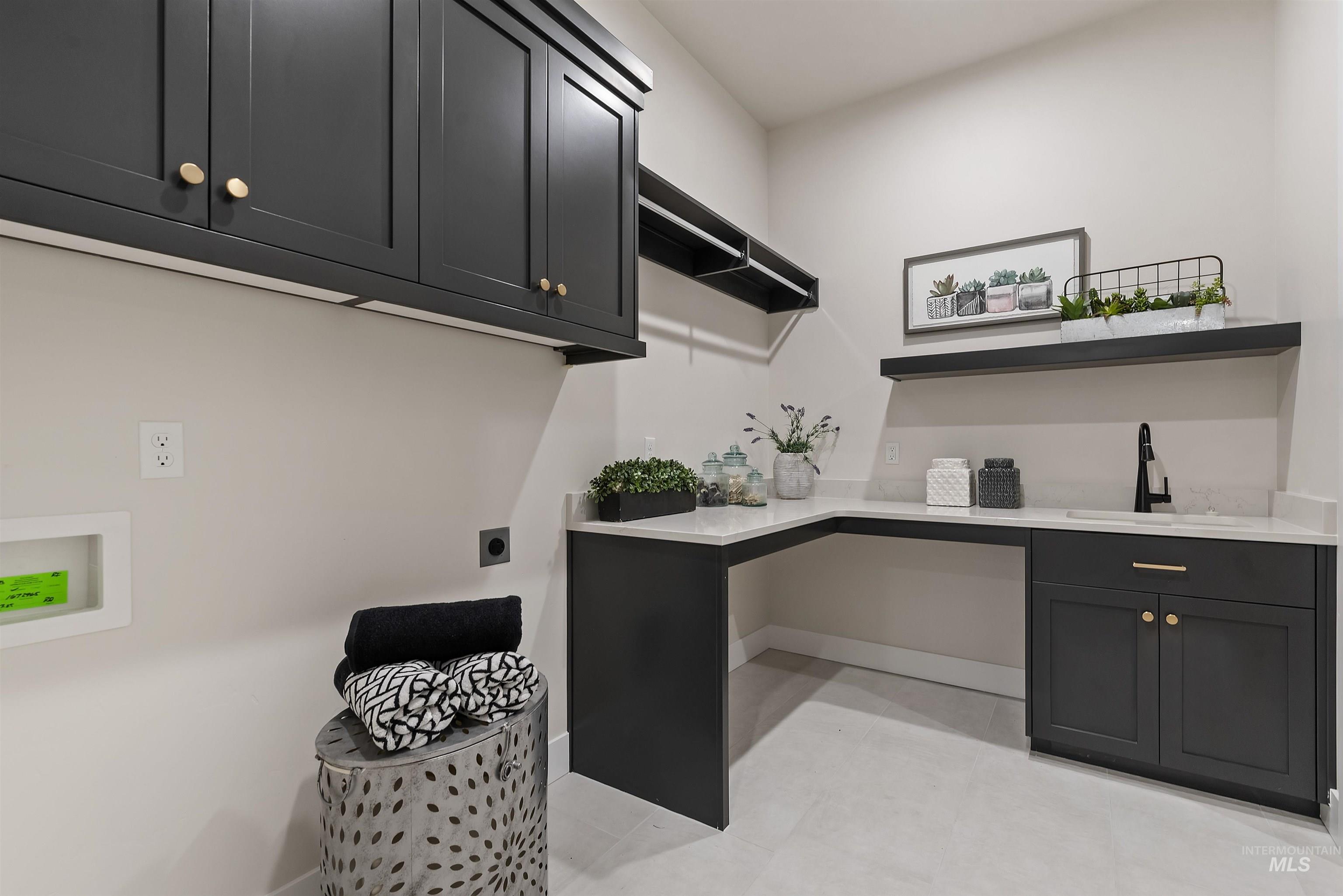 24864 Ardmore Court Caldwell, ID 83607 - Photo 40 of 48 Washroom with cabinet space, light tile patterned floors, washer hookup, and electric dryer hookup