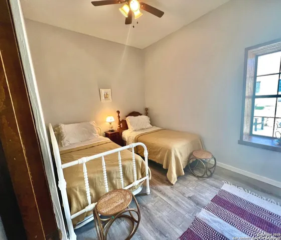 a bedroom with two beds and a chandelier