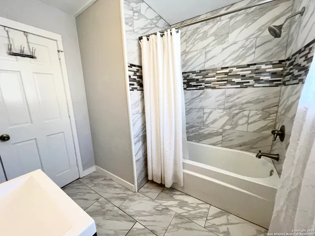 a bathroom with a shower and a tub