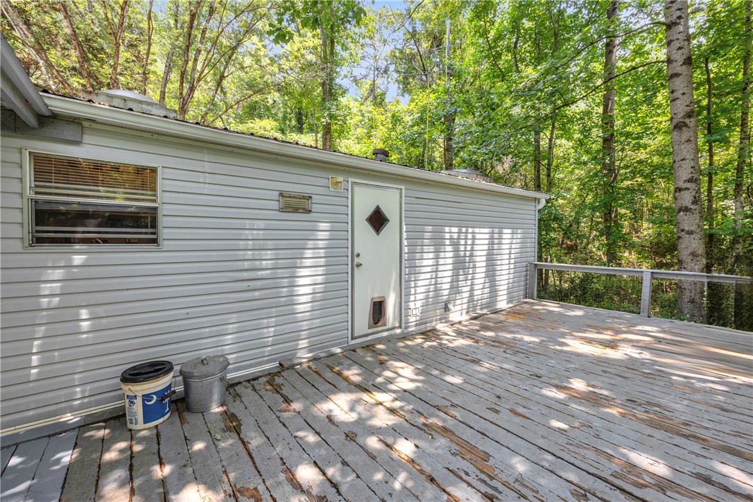 162 Newberry Road Walhalla, SC 29691 - Photo 35 of 50 A spacious wooden deck extends from the dwelling, offering a secluded outdoor retreat amidst lush forest views.