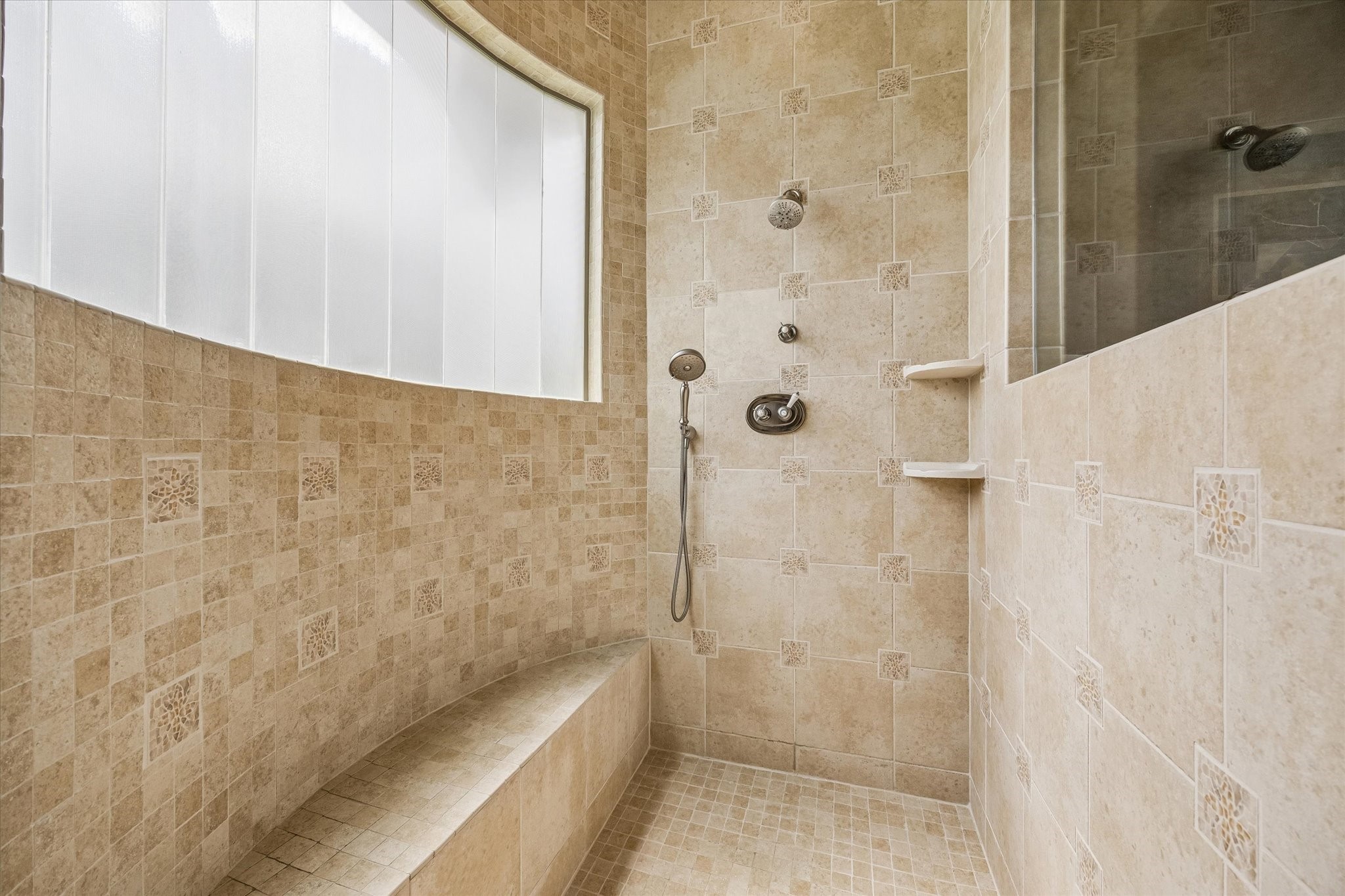 32102 Fulbrook Commons Fulshear, TX 77441 - Photo 22 of 50 The oversized walk-in shower showcases timeless tilework, built-in seating, and a bright window for natural light.