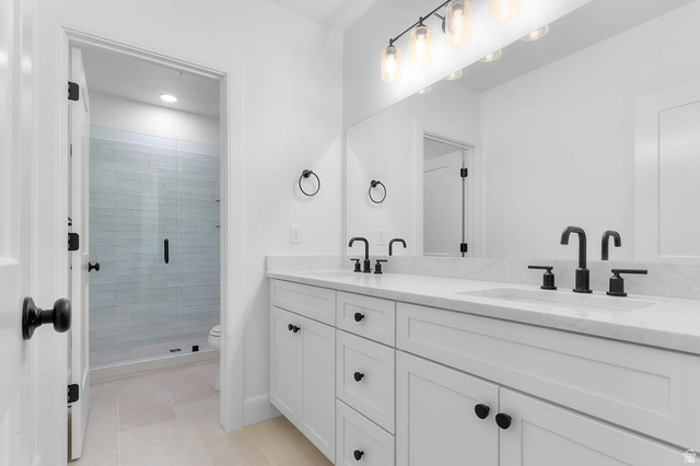 11711 South Halls Crk Road Draper, UT 84020 - Photo 27 of 31 Full bathroom featuring double vanity, a shower stall, light tile patterned flooring, and recessed lighting