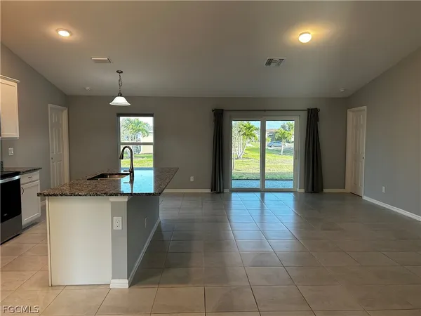 a view of a kitchen with a sink and a window