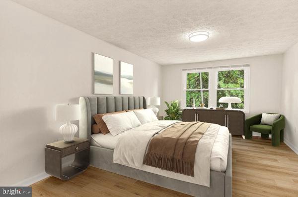 10640 Gorman Road Laurel, MD 20723 - Photo 15 of 25 a bedroom with a bed and wooden floor