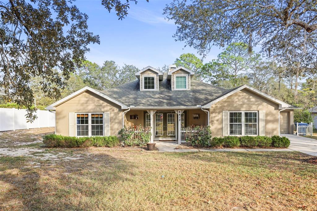 8412 Christopher Lane Weeki Wachee, FL 34613 - Photo 40 of 41 a front view of a house with a garden