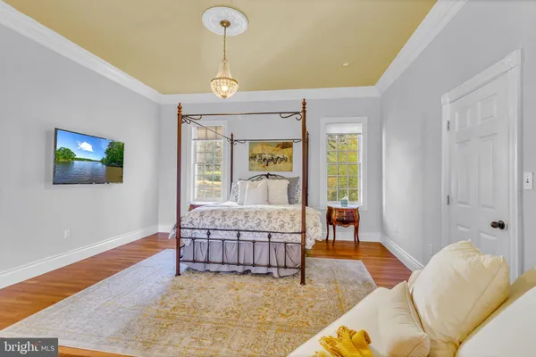 a bedroom with a bed and a chandelier
