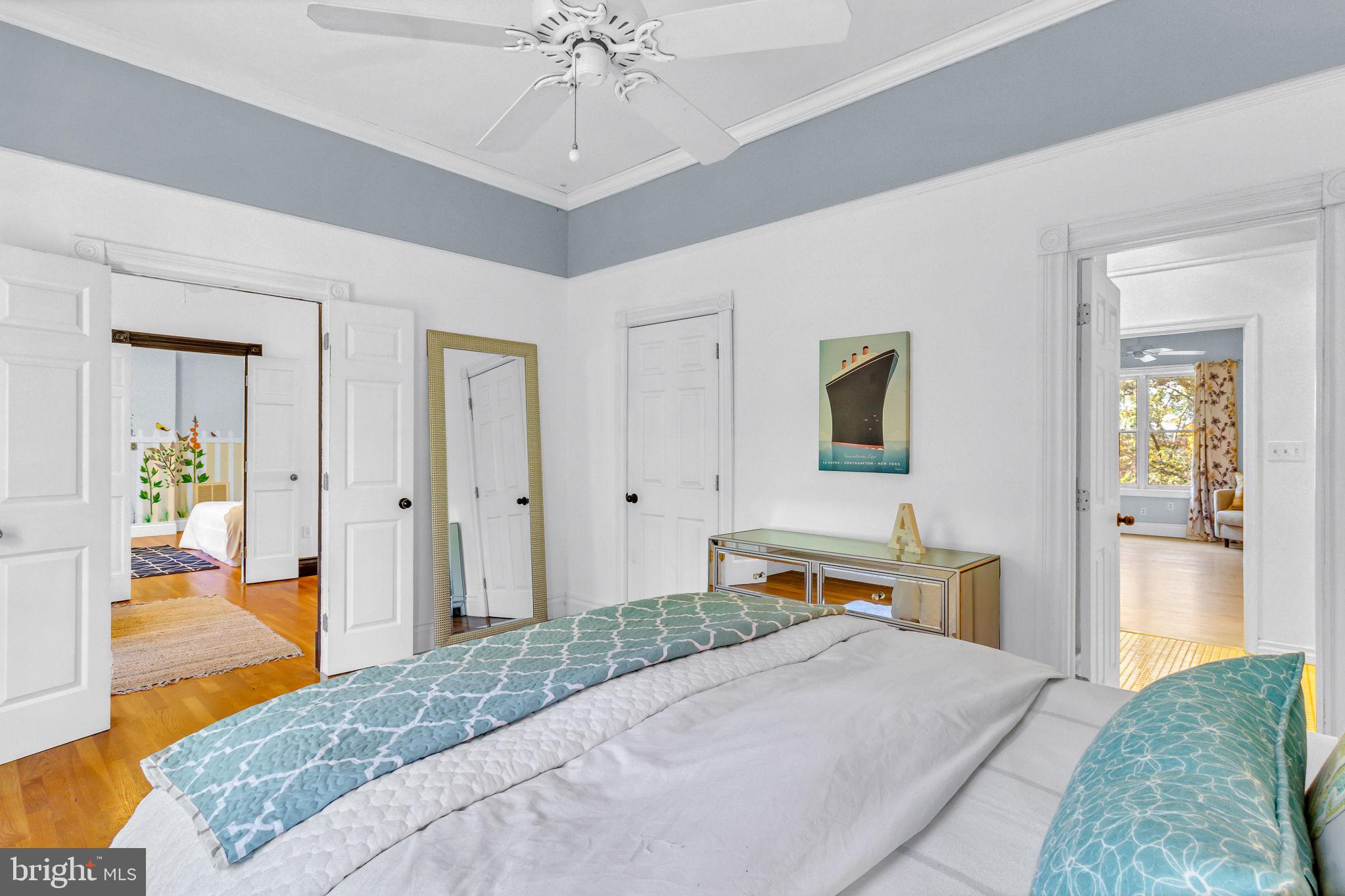 673 Nugent Road Weems, VA 22576 - Photo 48 of 72 a bedroom with a bed and a chandelier