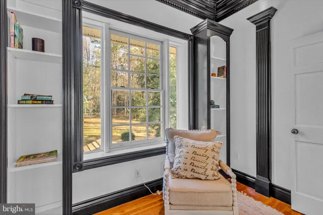 a view of backyard with table and chairs and large trees