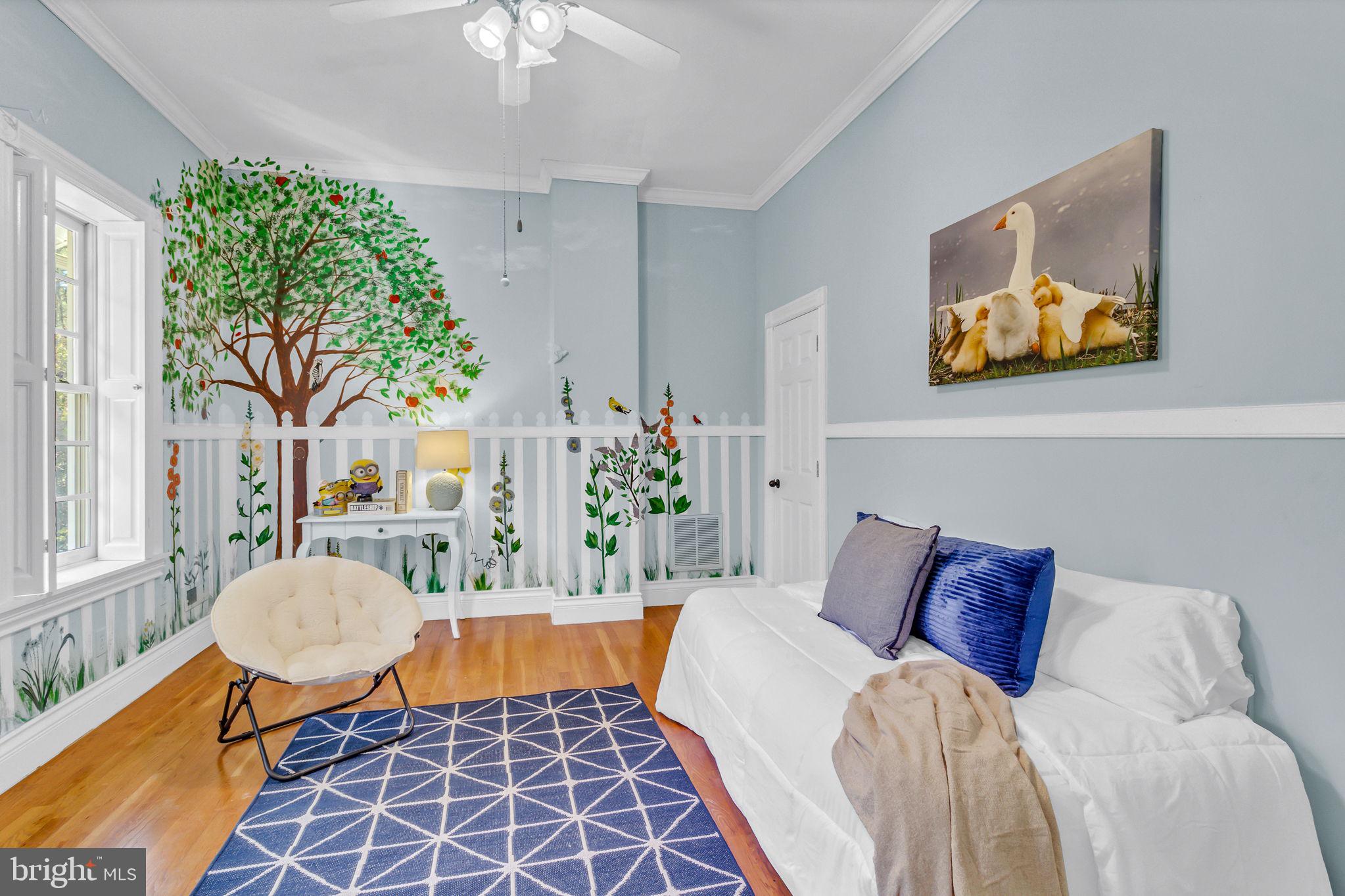 673 Nugent Road Weems, VA 22576 - Photo 50 of 72 a bedroom with a bed and a chandelier