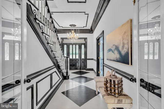 a dining room with furniture a chandelier and window