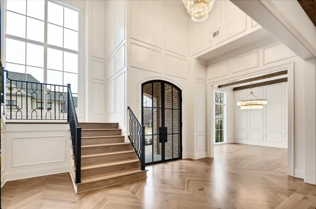 a view of a livingroom with wooden floor and a fireplace