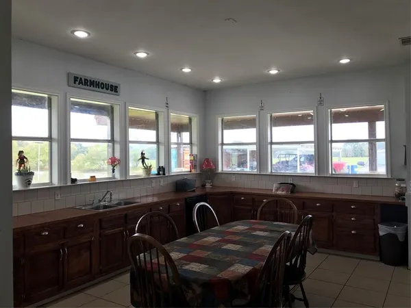 a kitchen with a sink and large windows
